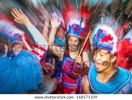 TAIPEI, TAIWAN - OCTOBER 19, 2013: Dream Community  held it\'s annual Carnival Parade in the streets. Aboriginal children\'s drumming teams, covered in feathers and glitter, marched along the streets.