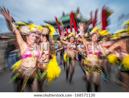 TAIPEI, TAIWAN - OCTOBER 19, 2013: Dream Community  held it's annual Carnival Parade in the streets. Aboriginal children's drumming teams, covered in feathers and glitter, marched along the streets.