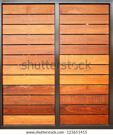 Stained wood framed in steel garage doors vertical