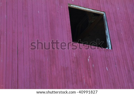 Square hole in a violet painted wood wall in Locke California