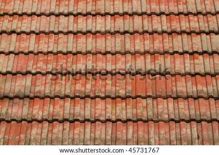 Faded corregated red tile roof in the sun