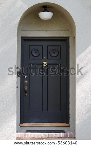 Black Front Door on tan stucco house