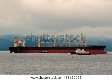 Freighter ship tug and pilot vessel at mouth of the columbia river