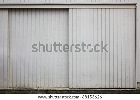 Old style Sliding beige painted wood garage doors