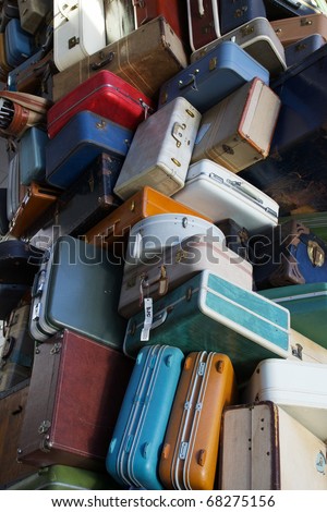 Pile of various styles of old luggage at airport or train station