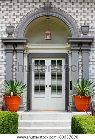 Elegant Home Front Door with gray wood arch and alternating brick work pattern