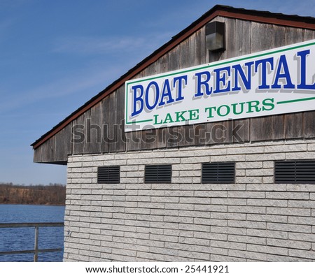 Sign on a building at the lake for Boat Rental or Lake Tours.
