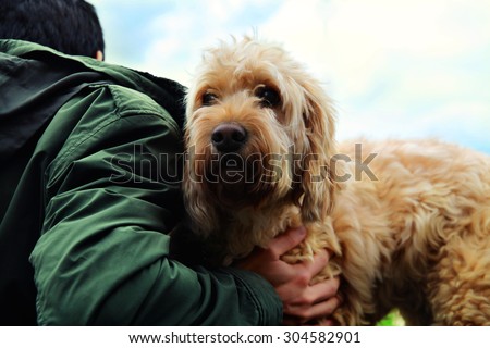 Man hugging dog.