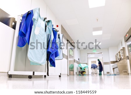 Doctor protective uniforms for surgery hanging in a light hospital corridor