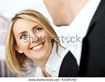Face of a beautiful white collar female worker smiling at her partner