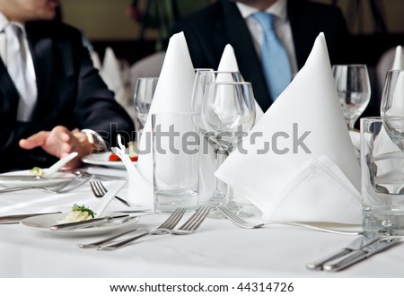 two business people no faces over a restaurant table