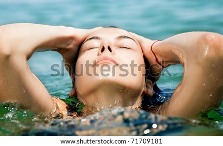 Close-up of young female face enjoying sea water