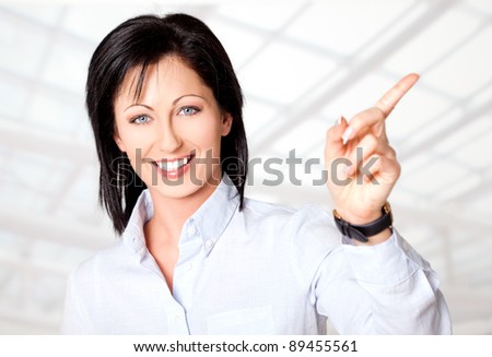 Portrait of beautiful woman smiling and pointing right direction