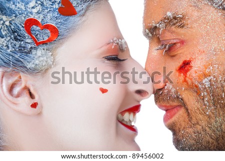 Close-up of happy make-up couple rubbing noses, faces covered with frost