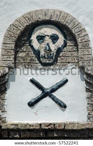 Skull and cross bones on a wall in Elmina castle in Ghana