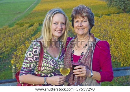 Mother and daughter drinking wine at a winery