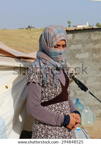 KANKE REFUGEE CAMP, DOHUK, KURDISTAN, IRAQ - 2015 JULY 4  - A Yazidi woman who escaped abuse from ISIS outside her tent in Kanke refugee camp