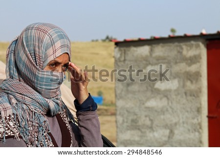 KANKE REFUGEE CAMP, DOHUK, KURDISTAN, IRAQ - 2015 JULY 4  - A Yazidi woman who escaped abuse from ISIS outside her tent in Kanke refugee camp
