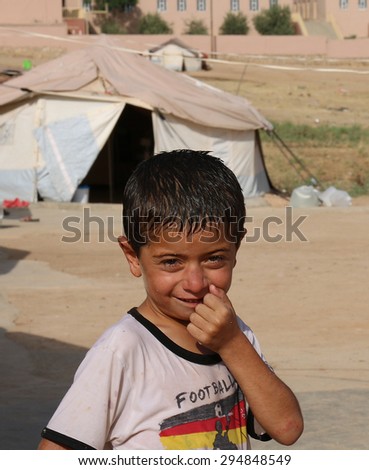 KANKE REFUGEE CAMP, DOHUK, KURDISTAN, IRAQ - 2015 JULY 4  - A young Yazidi boy posing for the camera inside Kanke refugee camp.
