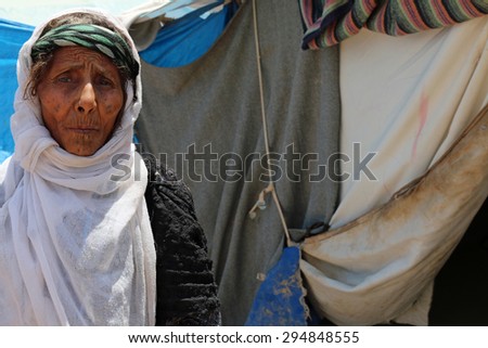 BAHARKA REFUGEE CAMP, ERBIL, KURDISTAN, IRAQ - 2015 JULY 1  - A elderly grandmother inside Baharka refugee camp.