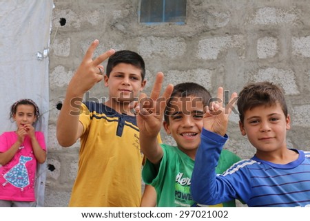 BAHKARA REFUGEE CAMP, ERBIL, KURDISTAN, IRAQ - 2015 JULY 16 - Playful children inside Bahkara (bahkara] refugee camp