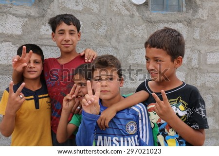 BAHKARA REFUGEE CAMP, ERBIL, KURDISTAN, IRAQ - 2015 JULY 16 - Playful children inside Bahkara (bahkara] refugee camp