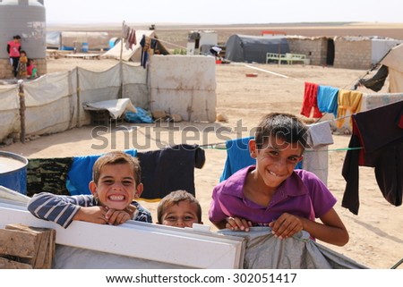 KHANKE REFUGEE CAMP, DOHUK, KURDISTAN, IRAQ - 2015 JULY 30 - Unidentified refugees smiling in Khanke (khanke) camp near Dohuk in Northern Iraq