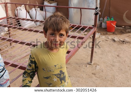 KHANKE REFUGEE CAMP, DOHUK, KURDISTAN, IRAQ - 2015 JULY 30 - Unidentified refugee boy in Khanke (khanke) camp near Dohuk in Northern Iraq