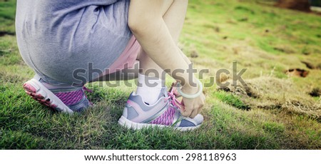 Running shoes. Barefoot running shoes closeup. Female athlete tying laces for jogging on road in minimalistic barefoot running shoes. Runner getting ready for training. Sport lifestyle