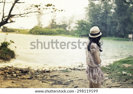 Outdoor portrait of young pretty woman posing near the sea alone and waiting for her sailor man husband