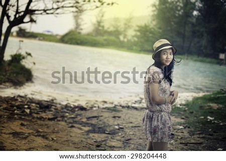 Outdoor portrait of young pretty woman posing near the sea alone and waiting for her sailor man husband