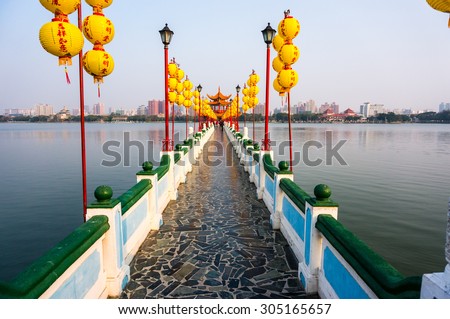 Path leading to temple in the middle of the lake, messages on the lanterns along the path translates to wishing good health, luck and prosperity.