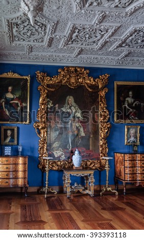 HILLEROD, DENMARK - 2014 JUN 08: Interior (One of the rooms of Frederiksborg Castle). Room with wooden parquet floors, and several antique chests. The ceiling with paintings and stucco.