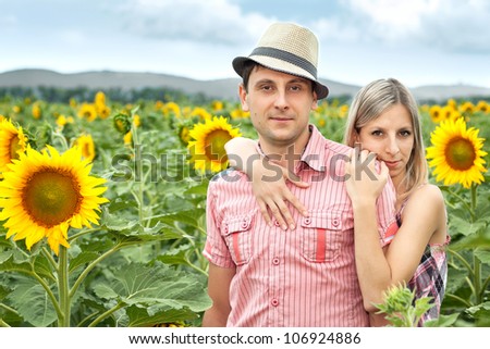 happy young pair in sunflowers