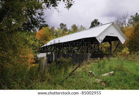 The Chamberlin Covered Bridge in Vermont with the leaves changing in fall