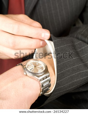 business man checking the time on his watch