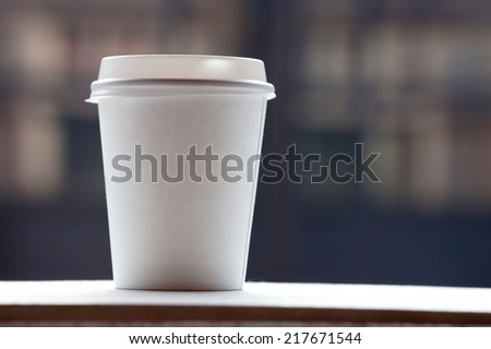 Disposable coffee cup on table
