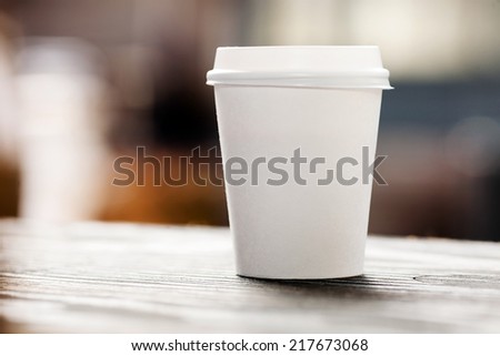 Disposable coffee cup on table