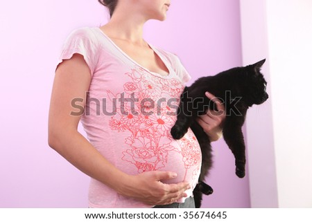 Pregnant woman with cat.