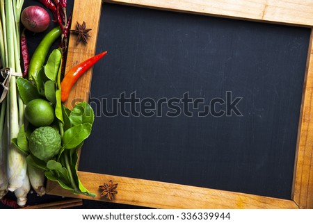 spices with ingredients and chalk board on dark background. asian food, healthy or cooking concept.