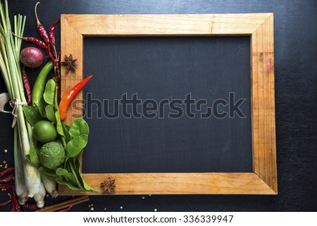 spices with ingredients and chalk board on dark background. asian food, healthy or cooking concept.