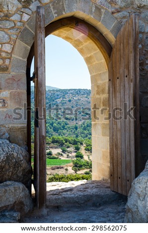 Views of the surrounding hills through the arch with open doors