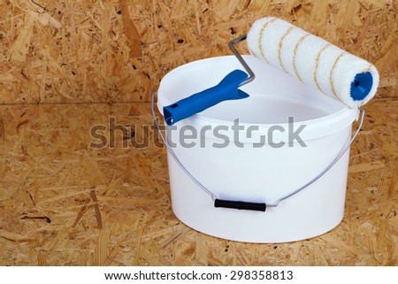 set for painting bucket of white paint roller