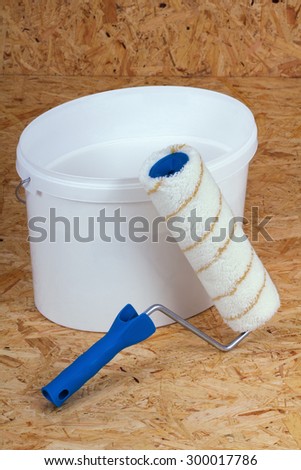 set for painting bucket of white paint roller