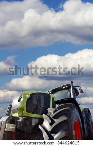 Tractor working on the farm, a modern agricultural transport, a farmer working in the field, tractor in the background cloudy sky, modern tractor closeup
