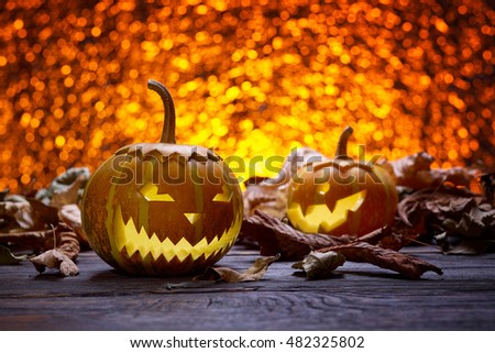 Pumpkin for Halloween, lamp pumpkin, antique wood, celebrating halloween, smiley on a pumpkin, autumn dry leaves, bright background, funny and angry face