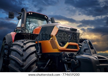 Tractor working on the farm, a modern agricultural transport, a farmer working in the field, tractor at sunset, modern tractor closeup