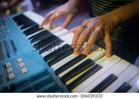 The pianist hand with ring on electric piano