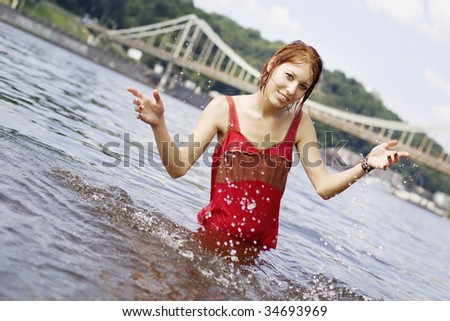 Red haired girl having fun in the water