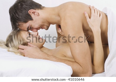 stock photo Loving affectionate nude heterosexual couple on bed